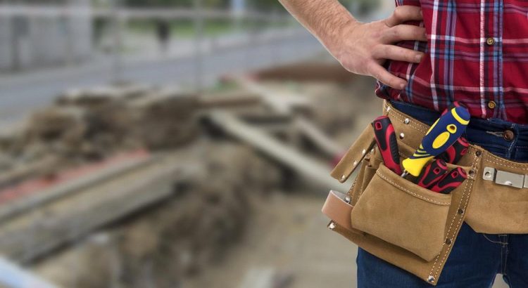 Handyman with a tool belt standing at a UAE residential worksite before starting maintenance work